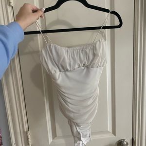 White slightly textured princess polly bodysuit.